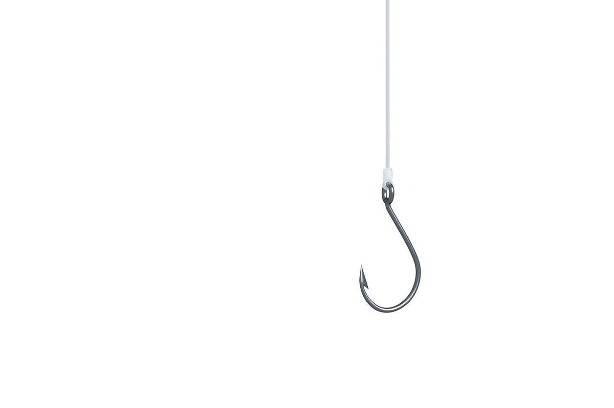 Fisherman baiting hook with precision using pliers on a long-shank fishing hook for sea fishing.