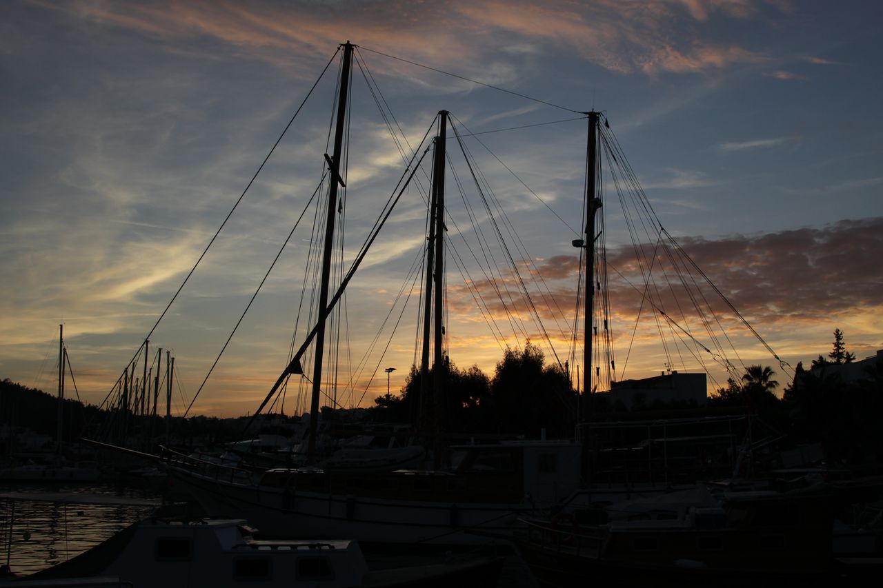 Voilier de 10 mètres au port de Bodrum, avec matériel d'entretien visible sur le pont.